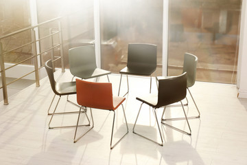 Chairs prepared for group therapy session in office. Meeting room interior