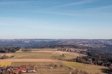 Obraz premium Little village in the middle of the german countryside with forests, fields and meadows