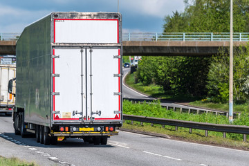 white box lorry truck on uk motorway in fast motion