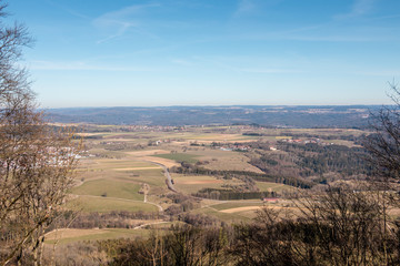 Little village in the middle of the german countryside with hills, forests, fields and meadows