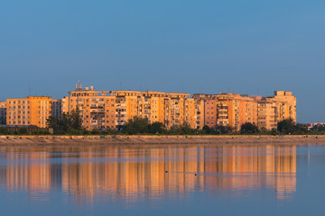 Buildings Lit by a Colorful Orange Sunset at the Lake