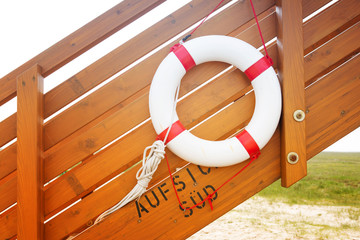 life ring on wooden stairs by the beach