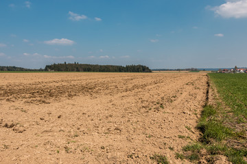Little village in the middle of the german countryside with hills, forests, fields and meadows