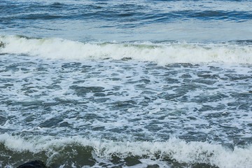 Abstract ocean waves with sea foam close-up. Stormy day on sea sandy beach in Miami 