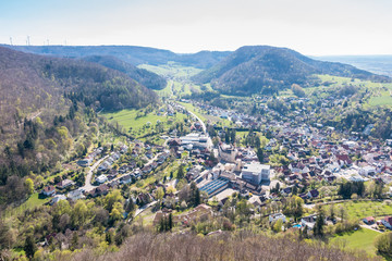 Little village in the middle of the german countryside with hills, forests, fields and meadows