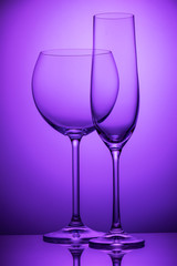 Two wineglasses on purple