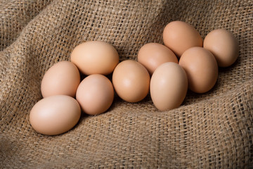 Eggs on natural burlap from a farm. Crude egg