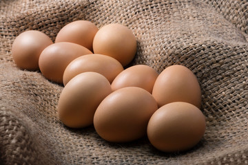 Fresh eggs from a poultry farm on burlap close up. Natural protein.