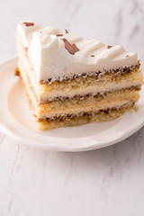 Tiramisu cake slice with white frosting