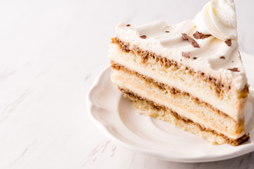 Tiramisu cake slice with white frosting
