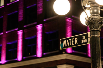 Close up of Water Street direction sign near Steam Clock in Gastown, Vancouver, Canada at Night time