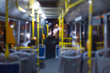 blurred photo, the bus is released in the evening, people rush home