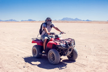 A group of quad bikes drive in the desert © Aleksej
