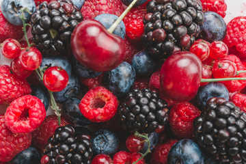 Fresh Summer Berries mix Background with Strawberry, Raspberry, Red currant, Blueberry and Blackberry.