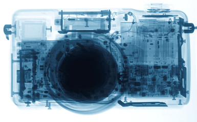 Сompact photo camera under the X-rays in blue tones