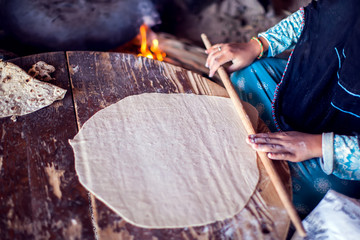 Arab woman makes bread in the beduin village in Egypt