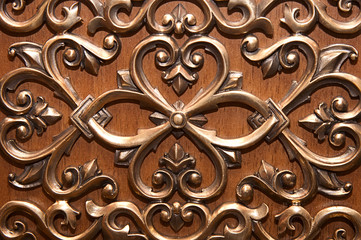 Metal bronze pattern on a wooden door
