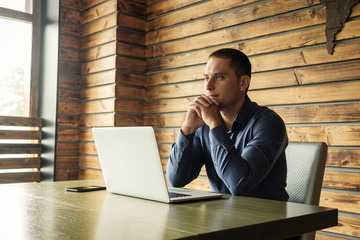 Pleased businessman or entrepreneur with a sitting working