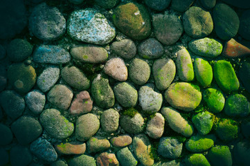 Sea stones background. Rounded stones texture. Colored cobblestone