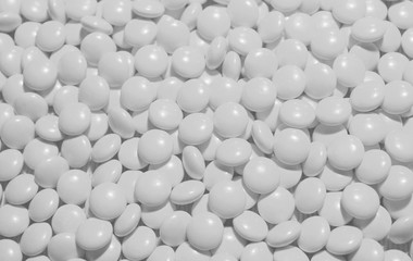 Scattering of white pills. Possibility of addiction to medication and excess dosage. Background in light tones ideal as backdrop for your text and other design elements.