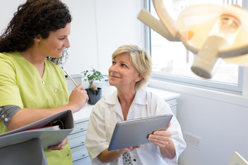 dental assistant listening to the dentist