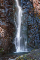 Fototapeta na wymiar Gveleti Big Waterfalls in a Dariali Gorge near the Kazbegi city in the mountains of the Caucasus, Geprgia