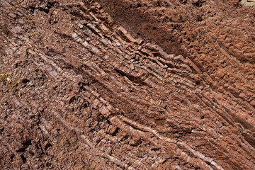 closeup rock in a crack, red natural background