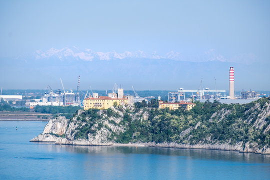 Castle Duino and harbor Monfalcone with mountains alps in Italy