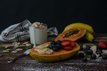 Dark table with fruits and yogur