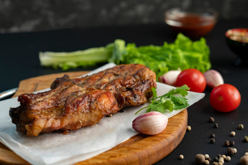 spicy beef steak cooked on a coal or barbecued, pepper and green letucce lay arounds