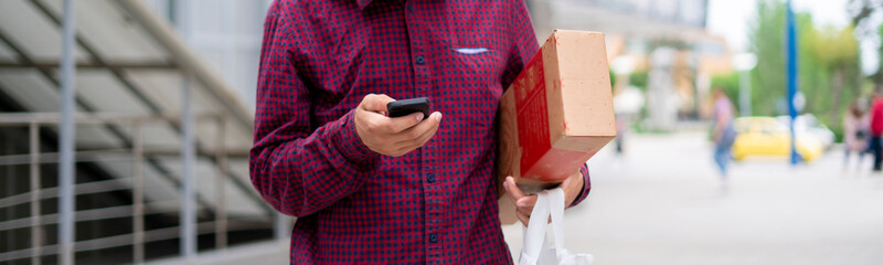 courier using a phone to searching the address path to deliver a packages