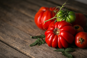 Fresh, ripe tomatoes on wood background.