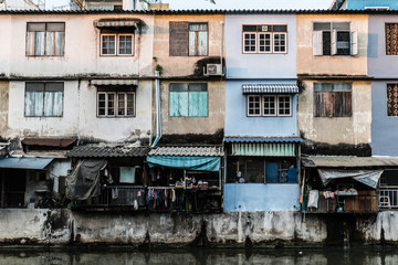 Fototapeta na wymiar Poor and run down houses along the river, urban decay