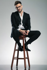 Guilty looking man sitting on a stool