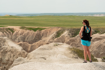 Female Tourist Looks Out Over Badlands