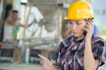 female construction worker using talkie walkie