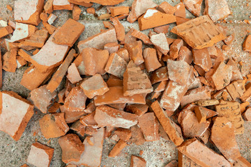broken bricks on a pile on the ground splinters on the construction site