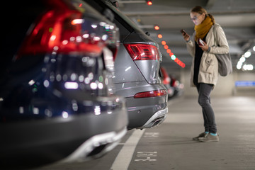 Underground garage or modern car parking with lots of vehicles, perspective of the row of the cars...