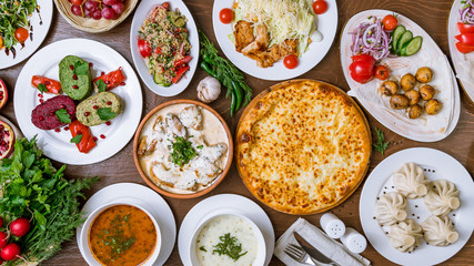 Fototapeta na wymiar Georgian cuisine foodset from khachapuri, khinkali, pkhali, dolma, satsivi top view