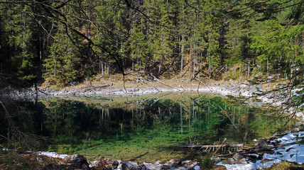 Eibsee, Bavaria, Germany - 30.03.2014, Eibsee lake view, fir trees, close to Garmisch-Partenkirchen village.