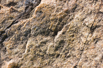 Background of granite. Texture of granite stone. Pattern of roughened surface. Texture of brown stone