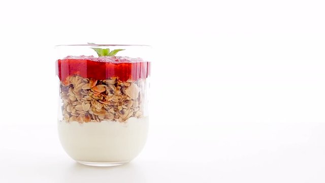 Homemade granola parfait with strawberry jam and mint, yogurt and muesli for healthy breakfast in the morning