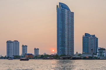 Fototapeta premium Skyline of Bangkok at the banks of the Chao Phraya River at sunset