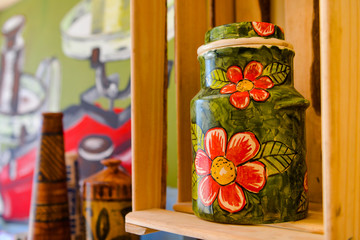 green ceramic vase with red flowers