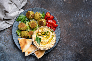 Chickpea hummus with falafel and pita bread. Vegan, vegetarian arabian food. Top view, Copy space