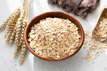 Oats or rolled oats or oat flakes in bowl. Healthy eating, healthy lifestyle, dieting and weight...