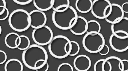 Abstract illustration of randomly arranged white rings with soft shadows on black background
