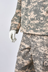 Right mannequins hand in soldiers uniform. Close up, cropped image. White isolated background.