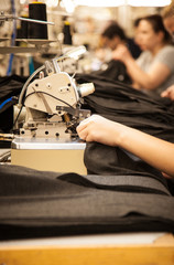 Textile workers at work on sewing machine