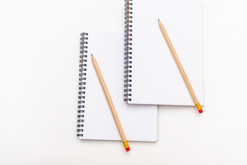 blank sheet of notebook with a spiral and pen on a white background. Copy space.